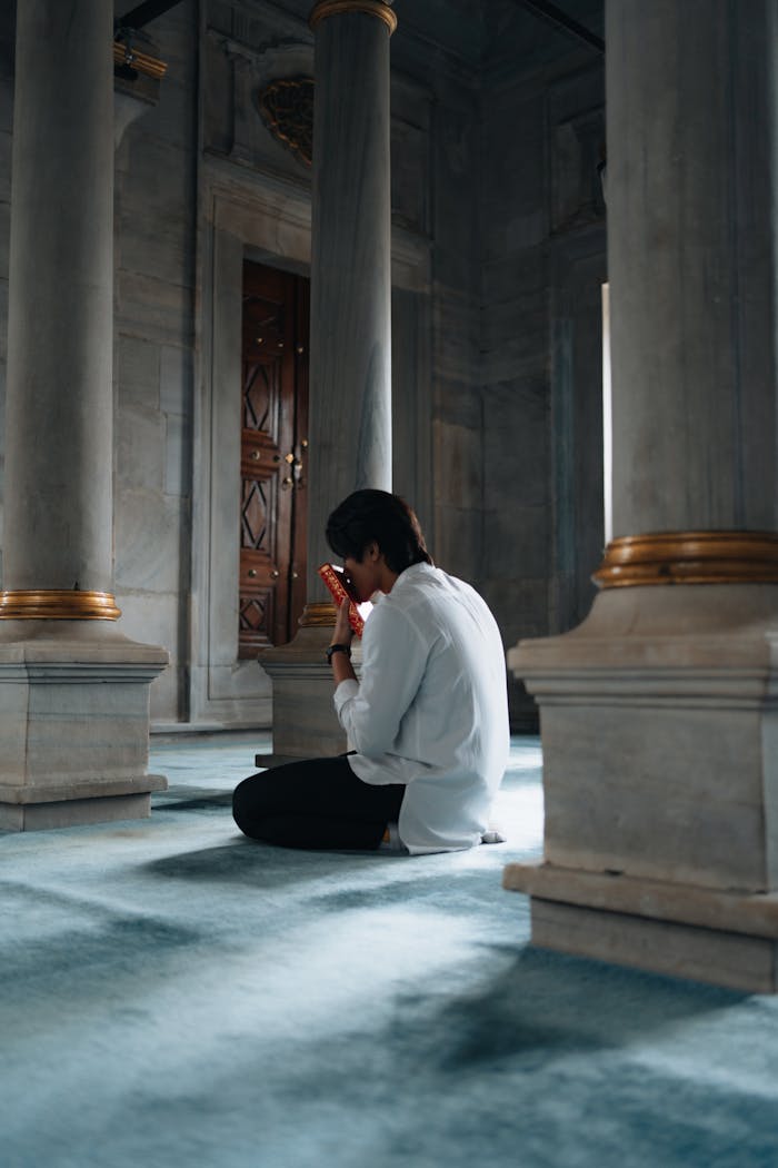 A man sitting on the floor in a mosque